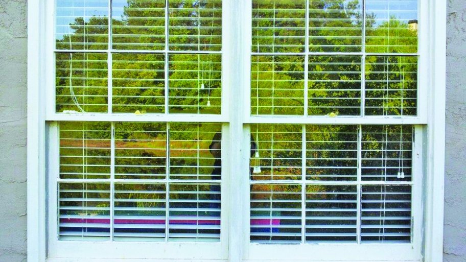 Windows sit with blinds partially open inside.